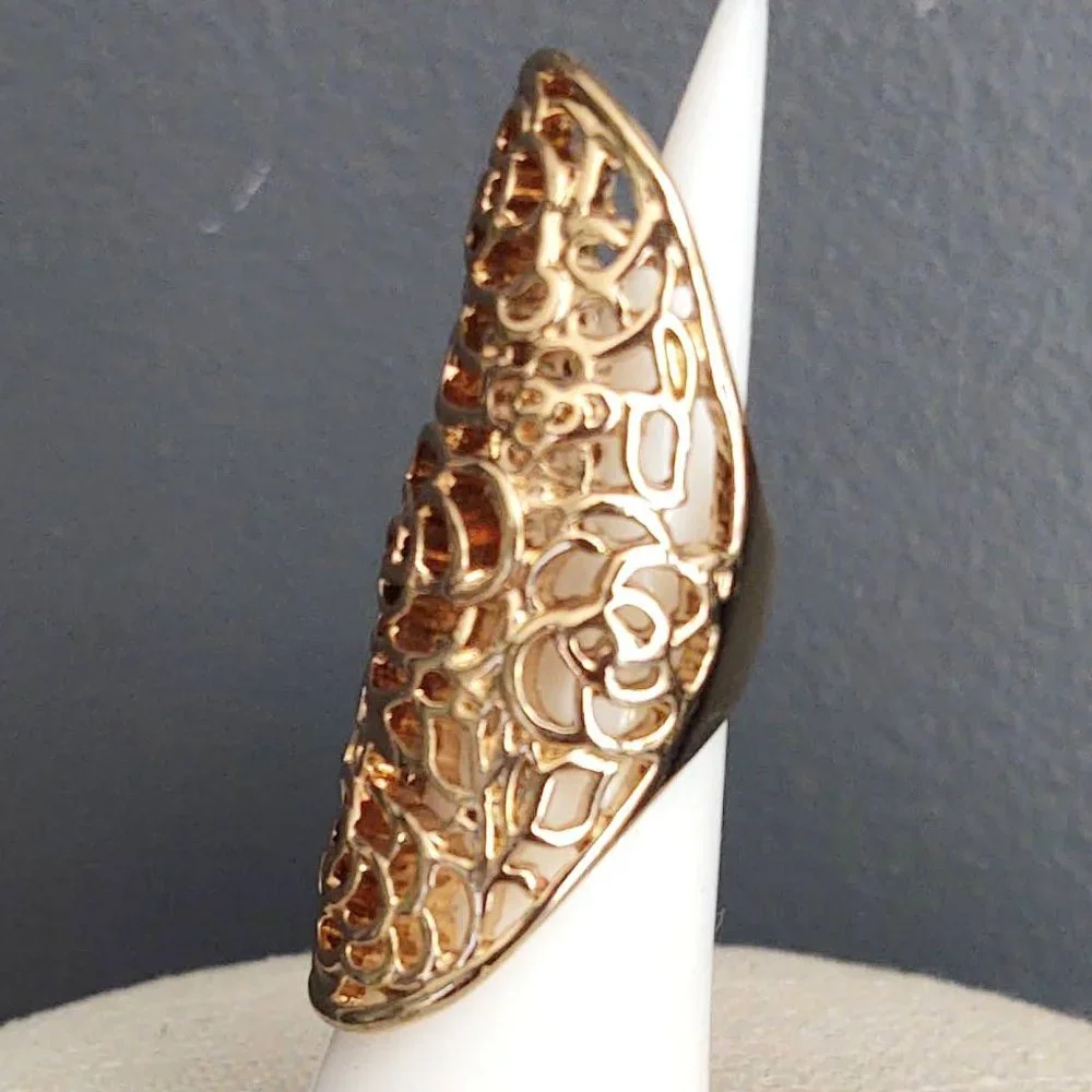 Long, open scroll design gold ring